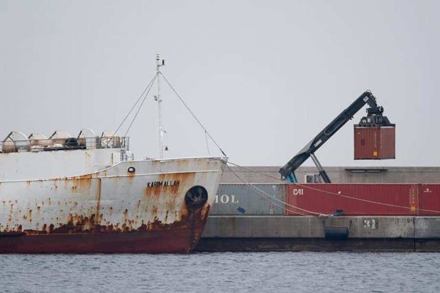 A crane moves a container next to livestock ship "Karim Allah", that carries nearly a thousand Spanish cattle stranded on ship with suspected bluetongue disease, at Escombreras port, in Cartagena, Spain, February 27, 2021. REUTERS/Juan Medina