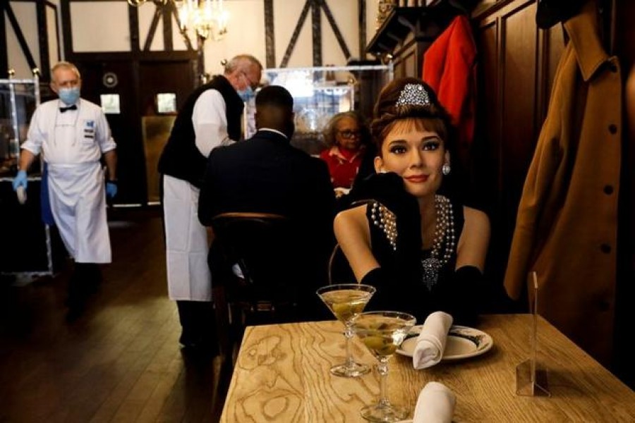 Madame Tussauds's wax figure of Audrey Hepburn sits at an empty table to comply with coronavirus disease (COVID-19) social distancing requirements in a dining room at Peter Luger Steak House in Brooklyn, New York ,US, February 26, 2021. REUTERS/Brendan McDermid