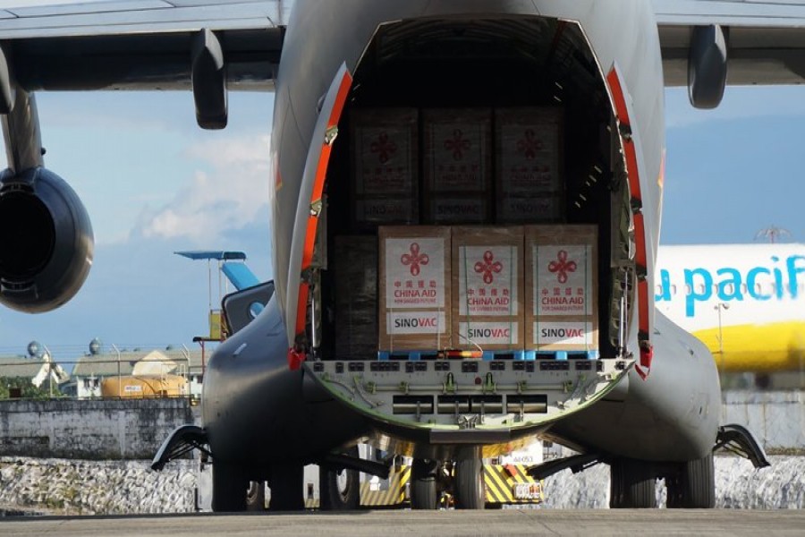 In this photo provided by the Presidential Communications Operations Office-Office of the Global Media Public Affairs, a Chinese military plane carrying the first batch of Sinovac vaccine from China arrives at the Villamor Air Base in Manila, Philippines on Sunday Feb. 28, 2021.  (PCOO-OGMPA via AP)