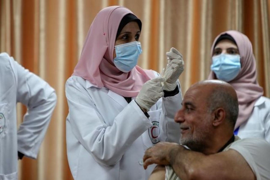 A health worker prepares to vaccinate former Palestinian health minister Jawad Tibi against the coronavirus disease (Covid-19) vaccine in Gaza City, February 22, 2021 — Reuters/Files