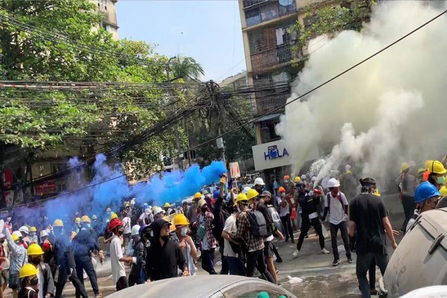 Protesters set off smoke grenades to block the view from snipers in Sanchaung, Yangon, Myanmar March 3, 2021, in this still image from a video obtained by Reuters — Video obtained by Reuters