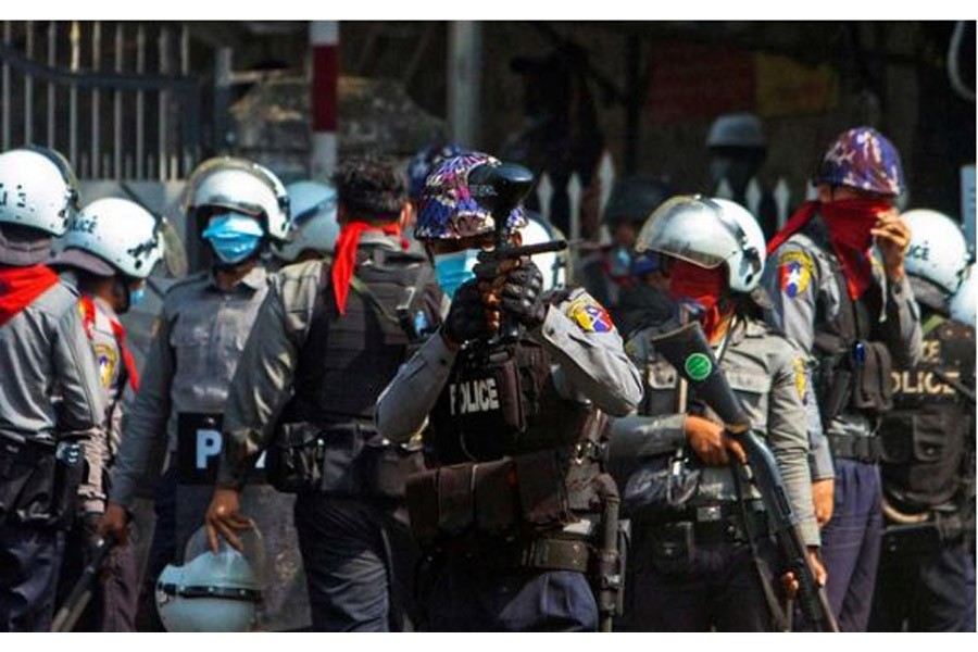 A riot police officer fires a rubber bullet toward protesters during a protest against the military coup in Yangon, Myanmar, Feb 28, 2021. REUTERS