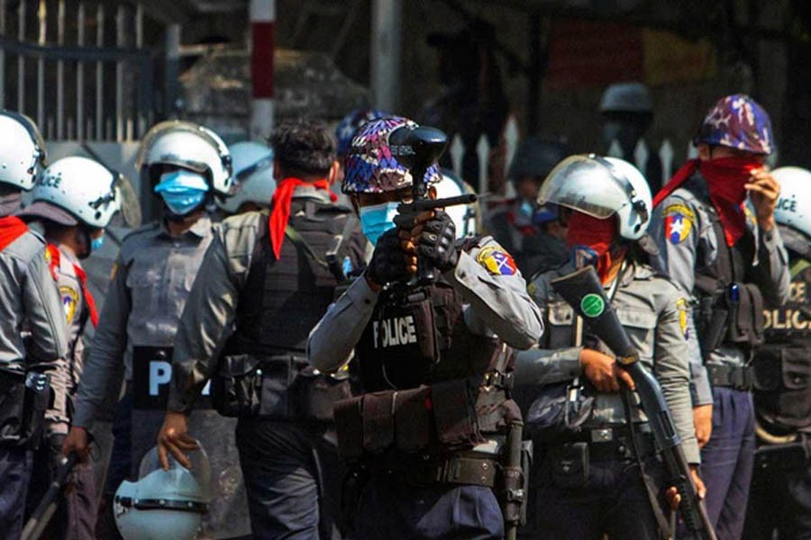 A riot police officer fires a rubber bullet toward protesters during a protest against the military coup in Yangon, Myanmar, Feb 28, 2021. REUTERS