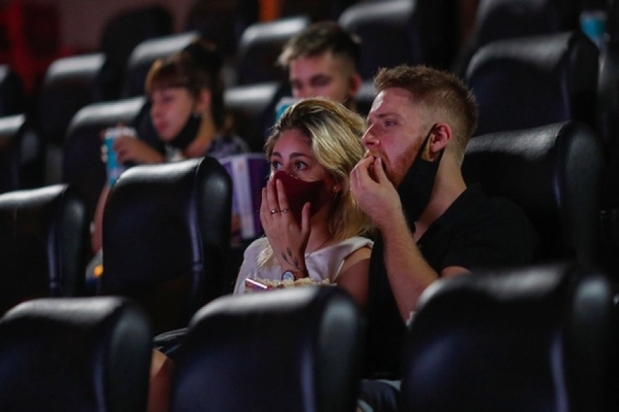 People wearing protective face masks are seen inside a movie theatre, as cinemas in Argentina reopen amid an easing of new coronavirus disease (Covid-19) infections, in Buenos Aires, Argentina, March 3, 2021 — Reuters/Files