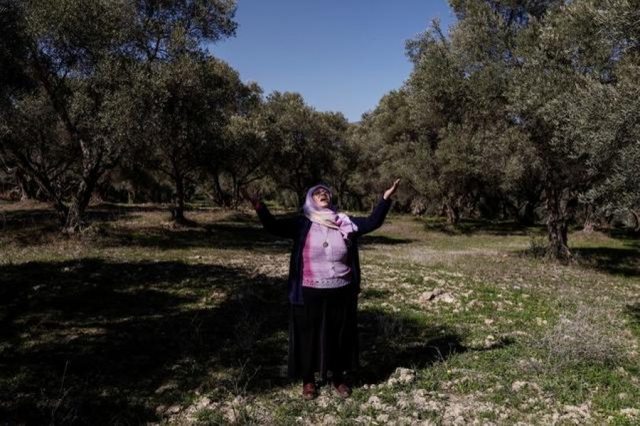 Tayyibe Demirel, 64, who is refusing to sell her olive grove to coal mining companies, prays as she stands in her olive grove in Turgut village near southwestern town of Yatagan in Mugla province, Turkey, February 24, 2021 — Reuters