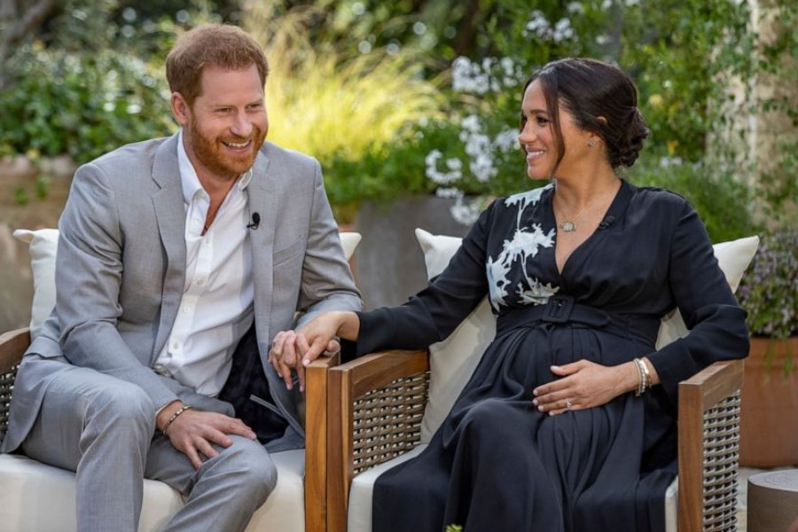 This image provided by Harpo Productions shows Prince Harry, left, and Meghan, Duchess of Sussex, speaking about expecting their second child during an interview with Oprah Winfrey. (Joe Pugliese/Harpo Productions via AP)