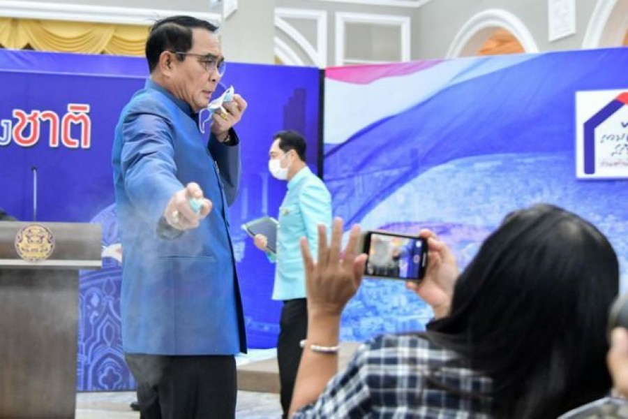 Irked Thai premier sprays reporters with hand sanitiser