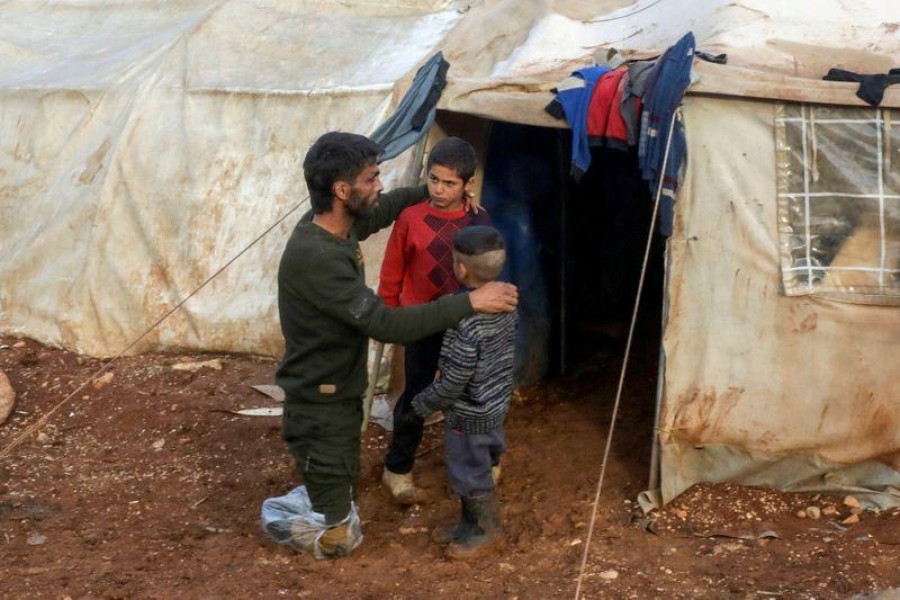 Ahmad Hamra, is pictured with his children outside of a tent at an internally displaced Syrian camp, in northern Aleppo near the Syrian-Turkish border, Syria on February 17, 2021 — Reuters/Files