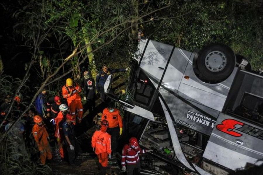 Rescue personnel work at the crash site after a bus fell into a ravine in Sumedang, West Java Province, Indonesia on March 10, 2021 — Antara Foto via REUTERS