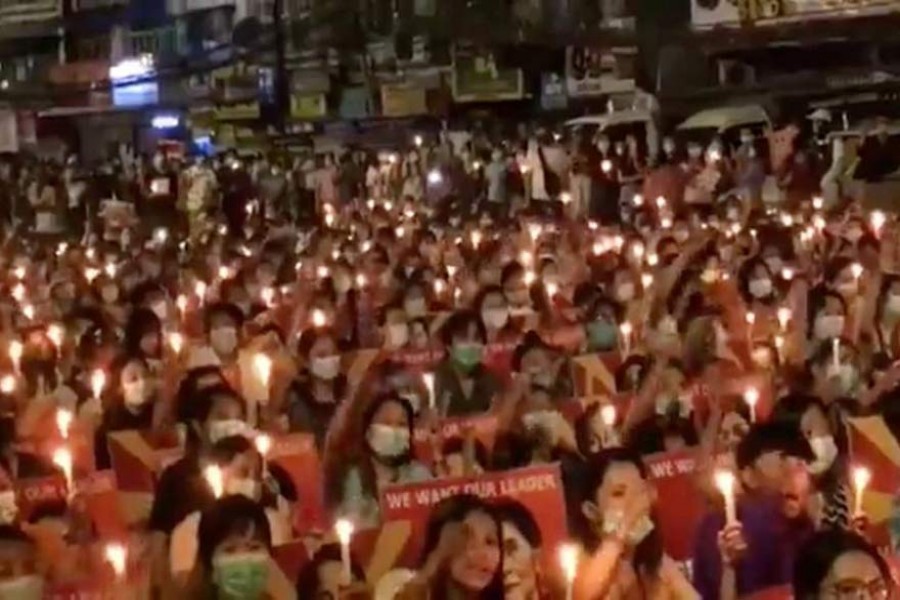 People take part in a candlelight gathering in Yangon, Myanmar, March 12, 2021, in this still image taken from video obtained by Reuters — Video Obtained by Reuters/via Reuters