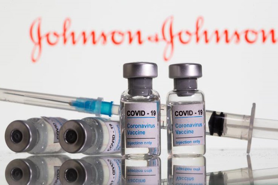 Vials labelled "COVID-19 Coronavirus Vaccine" and sryinge are seen in front of displayed Johnson&Johnson logo in this illustration taken on February 9, 2021 — Reuters/Files