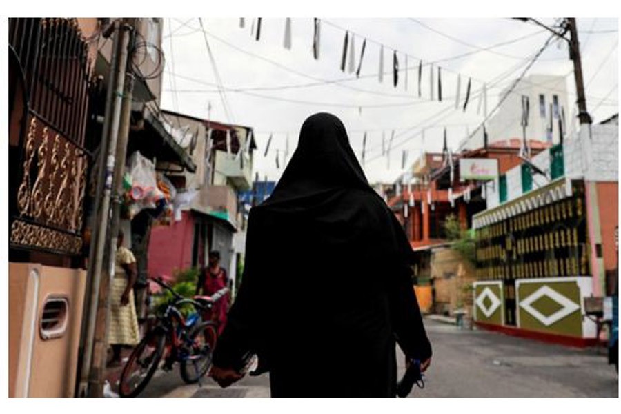 A Muslim woman wearing a hijab walks through a street near St Anthony's Shrine, days after a string of suicide bomb attacks across the island on Easter Sunday, in Colombo, Sri Lanka, April 29, 2019. REUTERS