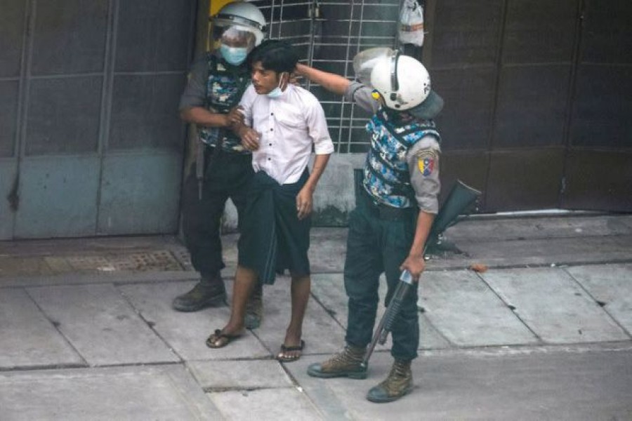 Riot police officers detain a demonstrator during a protest against the military coup in Yangon, Myanmar on March 19, 2021 — Reuters photo