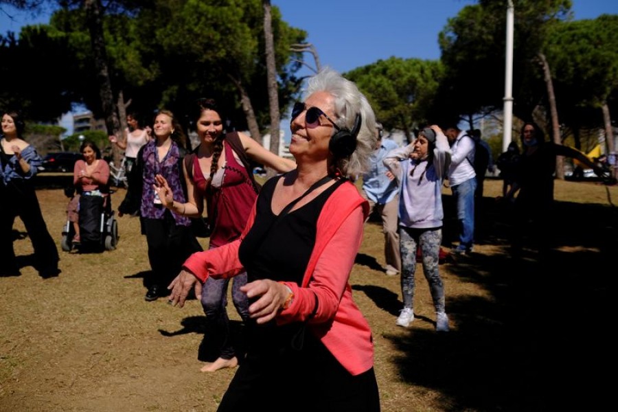 Barcelona residents use their headphones while listening to music as they dance during a socially-distant silent disco event on the first Spring weekend at Mar Bella beach in Barcelona, Spain on March 21, 2021 — Reuters/Files