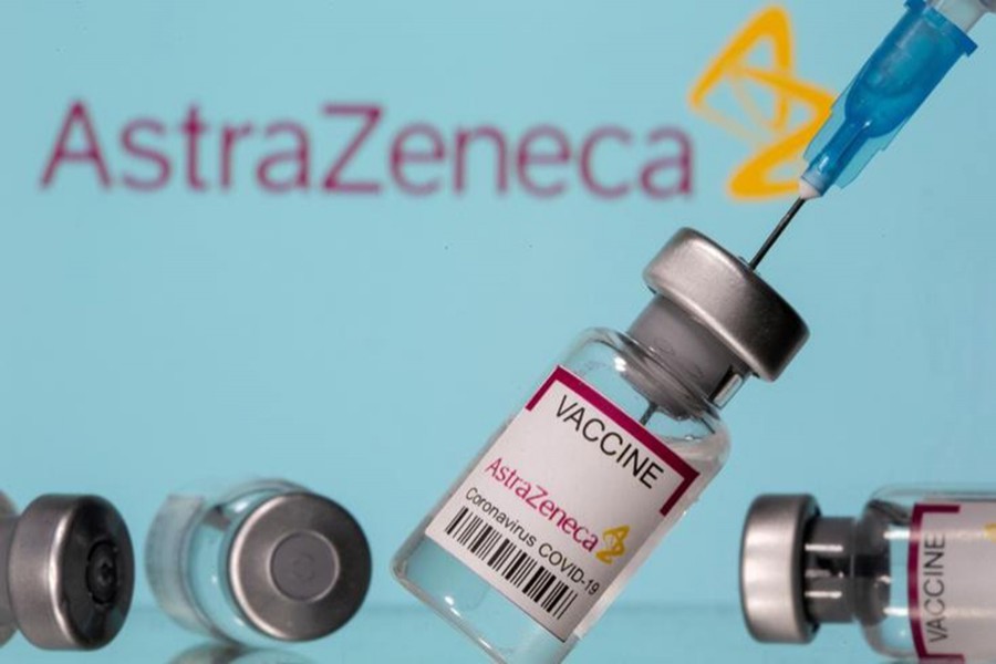 Vials labelled "Astra Zeneca COVID-19 Coronavirus Vaccine" and a syringe are seen in front of a displayed AstraZeneca logo, in this illustration photo taken on March 14, 2021 — Reuters/Files