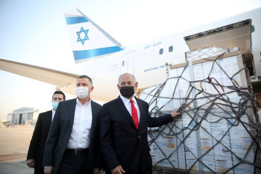 Israel Prime Minister Benjamin Netanyahu and Health Minister Yuli Edelstein attend the arrival of a plane with a shipment of Pfizer-BioNTech coronavirus disease (Covid -19) vaccines, at Ben Gurion airport, near the city of Lod, Israel, January 10, 2021. Motti Millrod/Pool via Reuters