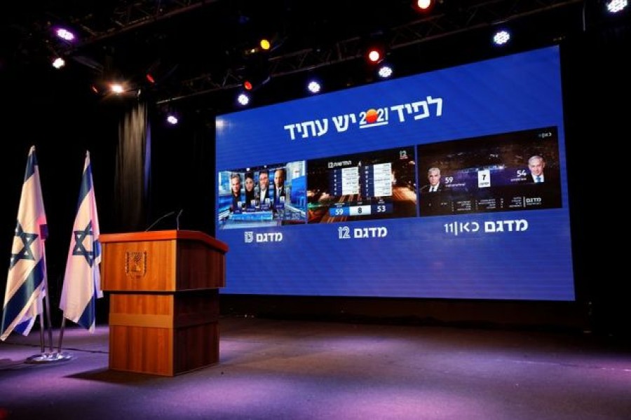The results of the exit polls in Israel's general election are shown on a screens at Yair Lapid's Yesh Atid party headquarters in Tel Aviv, Israel on March 23, 2021 — Reuters photo