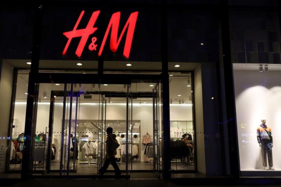 FILE PHOTO: A woman enters a store of the Swedish fashion retailer H&M at a shopping mall in Beijing, China March 24, 2021. REUTERS/Florence Lo