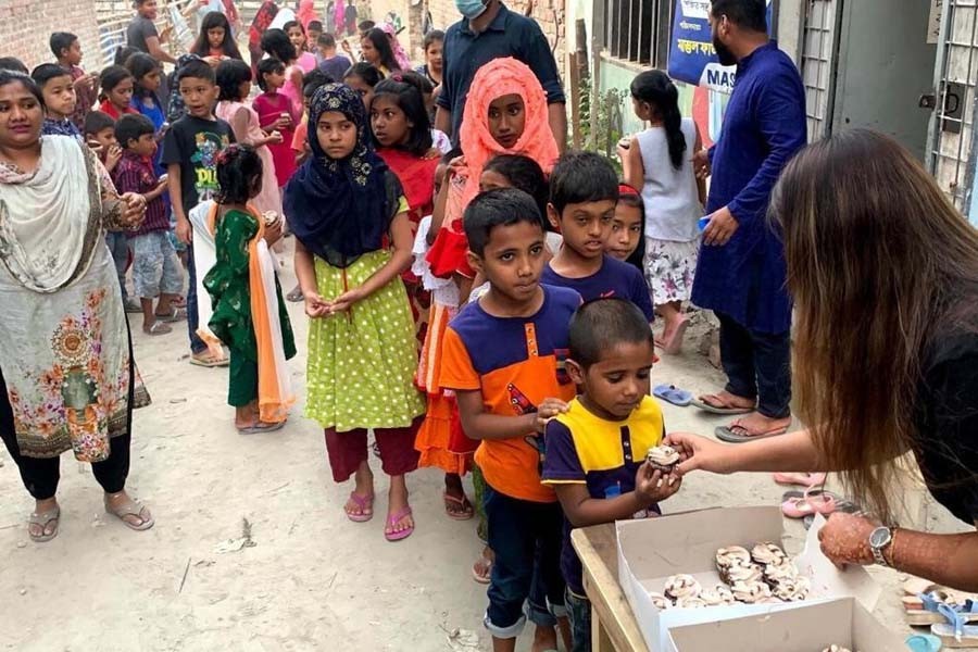 Poriborton Foundation distributing cupcakes among the underprivileged children at Rayer Bazar in the capital