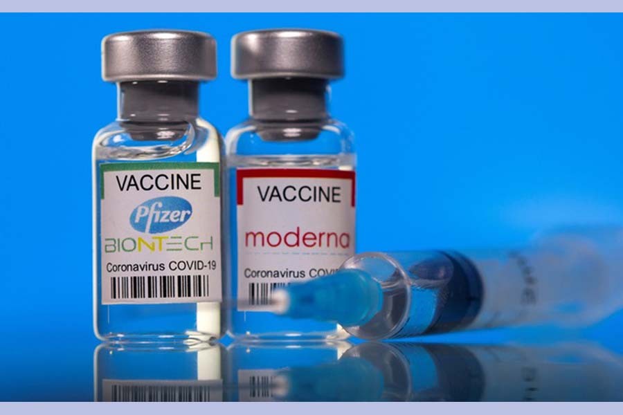 Vials with Pfizer-BioNTech and Moderna coronavirus disease (COVID-19) vaccine labels are seen in this illustration picture taken Mar 19, 2021. REUTERS   