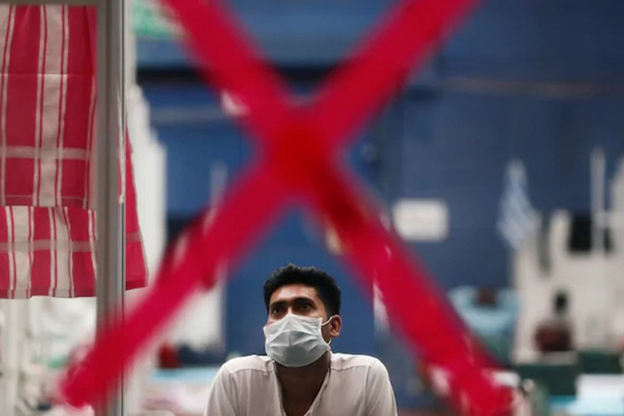 A man watches television inside a Covid-19 care centre at CWG Sports Complex in New Delhi, India on July 20, 2020 — Reuters/Files