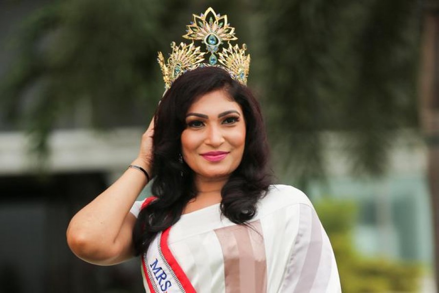 Pushpika De Silva poses for photographs with her Mrs Sri Lanka crown after it was forcibly removed by the reigning Mrs World, Caroline Jurie at the Mrs Sri Lanka contest, in Colombo, Sri Lanka, April 6, 2021. Picture taken April 6, 2021. REUTERS/Stringer