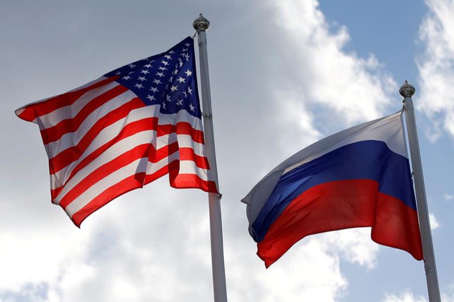 Russian and U.S. state flags fly near a factory in Vsevolozhsk, Leningrad Region, Russia on March 27, 2019 — Reuters/Files