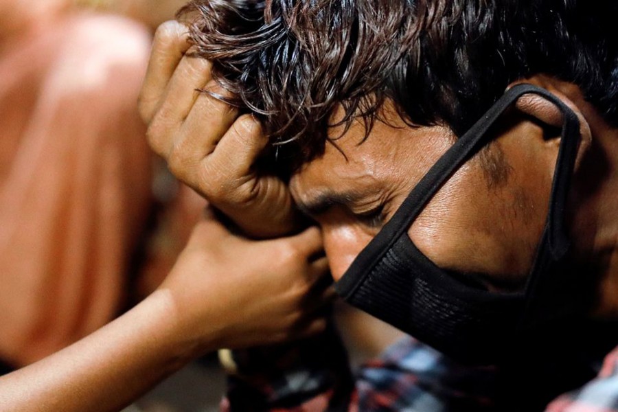 Migrant worker Anshul Kumar, 26, cries as he lost his money at a bus station, during a six-day lockdown imposed by the Delhi government to limit the spread of the coronavirus disease (Covid-19), in Ghaziabad on the outskirts of New Delhi, India on April 19, 2021 — Reuters photo