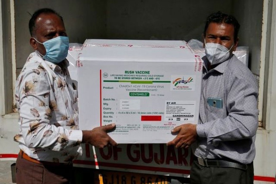 Officials unload boxes containing vials of AstraZeneca's COVISHIELD, a coronavirus disease (COVID-19) vaccine manufactured by Serum Institute of India, outside a vaccination storage centre in Ahmedabad, India, January 12, 2021. REUTERS