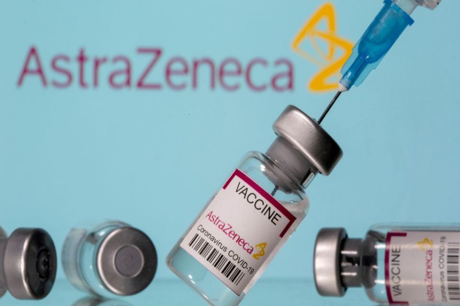 Vials labelled "Astra Zeneca COVID-19 Coronavirus Vaccine" and a syringe are seen in front of a displayed AstraZeneca logo, in this illustration photo taken on March 14, 2021 — Reuters/Files