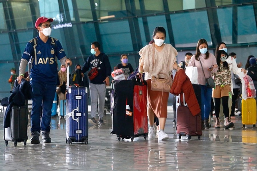 Visitors walk after they arrived at the Soekarno-Hatta Airport following Indonesia's government decision to ban foreign tourists from entry to prevent the spread of coronavirus disease (Covid-19), in Tangerang, on the outskirts of Jakarta, Indonesia, Jan 1, 2021 — Reuters/Files