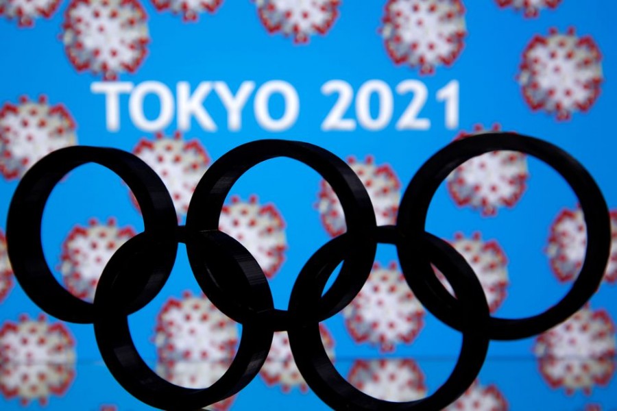 A 3D printed Olympics logo is seen in front of displayed "Tokyo 2021" words in this illustration taken March 24, 2020. REUTERS/Dado Ruvic TPX IMAGES OF THE DAY