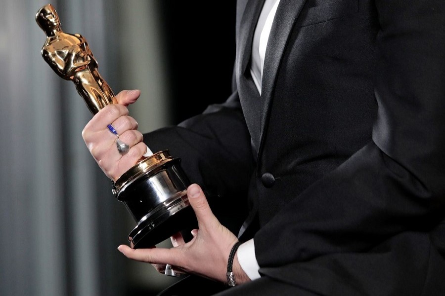 Florian Zeller holds his Oscars statuette after winning the Best Adapted Screenplay for the "The Father" at a screening of the Oscars in Paris, France, April 26, 2021 — Lewis Joly/Pool via Reuters