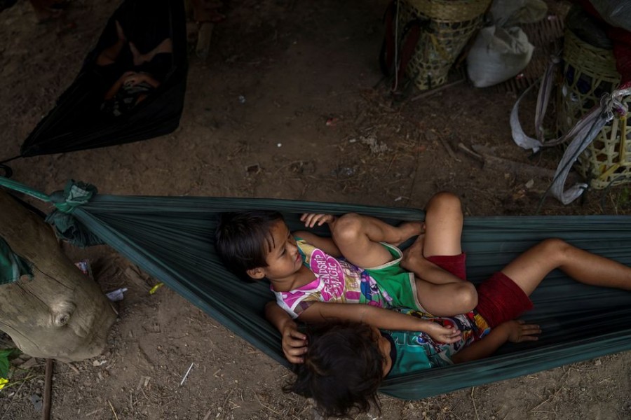 Children sit in a hammock near the Burmese border in Mae Hong Son province, Thailand, while fleeing from gunfire between ethnic minority Karen insurgents and Myanmar military, April 29, 2021. REUTERS/Athit Perawongmetha