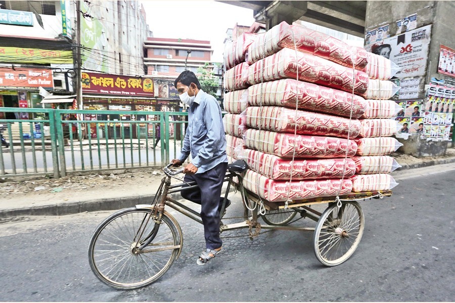 A rickshaw van carrying puffed rice (muri) from a factory to retailers in Jatrabari area of the city on Friday. The demand for puffed rice, an obvious item for Iftar of the Bangladeshis, usually increases during Ramadan — FE photo KAZ Sumon