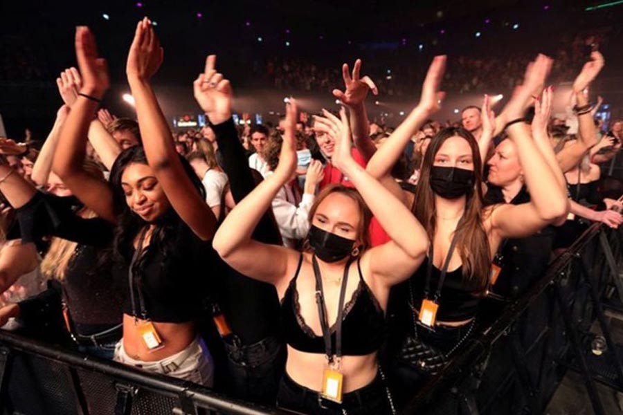People attend a music event at Ziggo Dome venue, which opened its doors to small groups of people that have been tested negative of the coronavirus disease (COVID-19) in Amsterdam, Netherlands March 6, 2021. REUTERS