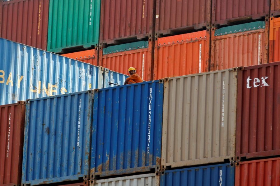 A worker sits on a ship carrying containers at Mundra Port in the western Indian state of Gujarat, April 1, 2014 — Reuters/Files