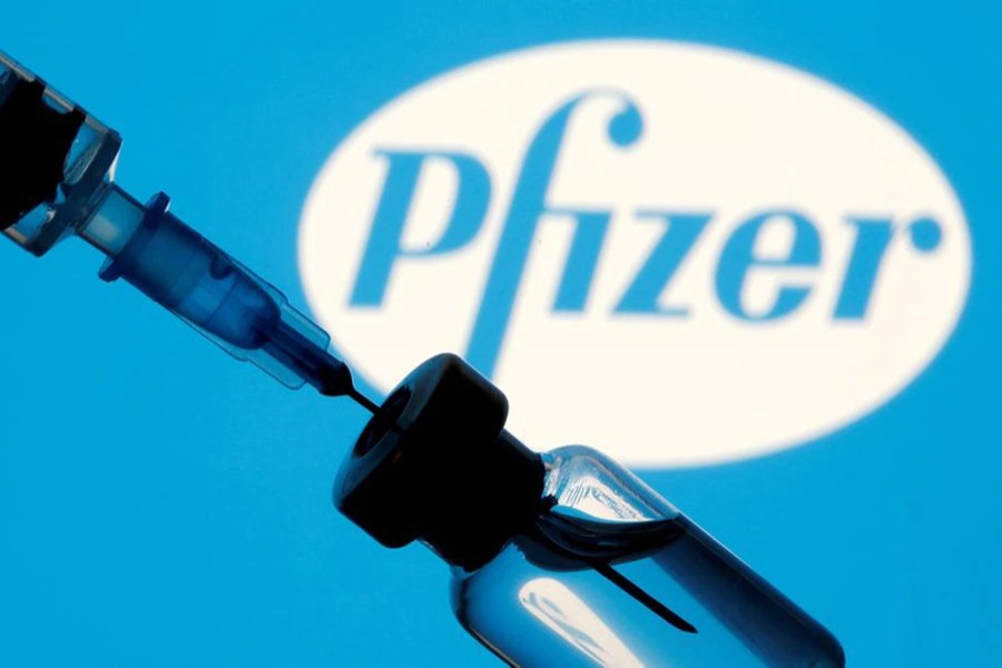 A vial and syringe are seen in front of a displayed Pfizer logo in this illustration taken on January 11, 2021 — Reuters/Files