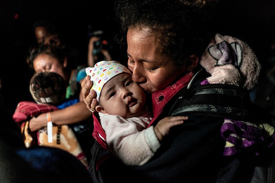 Ceidy, an asylum-seeking migrant mother from Guatemala, kisses her 3-month-old baby Bridget while waiting to be escorted by the US Border Patrol agents after crossing the Rio Grande river into the United States from Mexico in Roma, Texas, US on April 7, 2021 — Reuters/Files