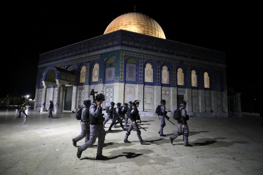 Israeli police walk near the Dome of the Rock during clashes with Palestinians at a compound known to Muslims as Noble Sanctuary and to Jews as Temple Mount, amid tension over the possible eviction of several Palestinian families from homes on land claimed by Jewish settlers in the Sheikh Jarrah neighbourhood, in Jerusalem's Old City on May 7, 2021 — Reuters photo