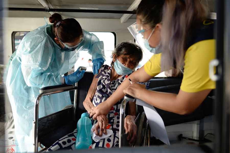 Felipa Tabladillo, 86, receiving a dose of China's Sinovac Biotech coronavirus disease (COVID-19) vaccine at a drive-thru vaccination site for bedridden and persons with disabilities in Metro Manila of Philippines on May 7 -Reuters file photo