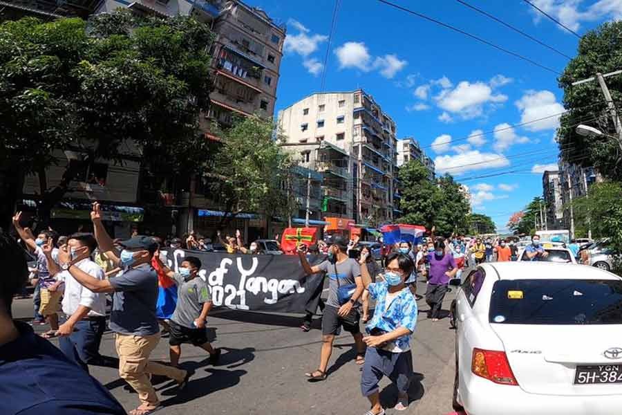 Demonstrators are displaying the three-finger salute during a protest against Myanmar's junta in Yangon on Tuesday. This still image was taken from a video footage. -Reuters