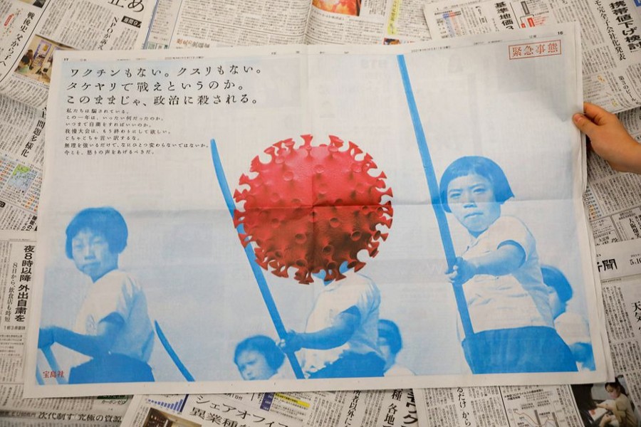 A full-page ad by magazine publisher Takarajimasha, with message reading 'No vaccine, no medication. Are we supposed to fight with bamboo spears? If things continue as they are, politics are going to kill us,' is seen on a newspaper in Tokyo on Japan May 11, 2021 — Reuters photo