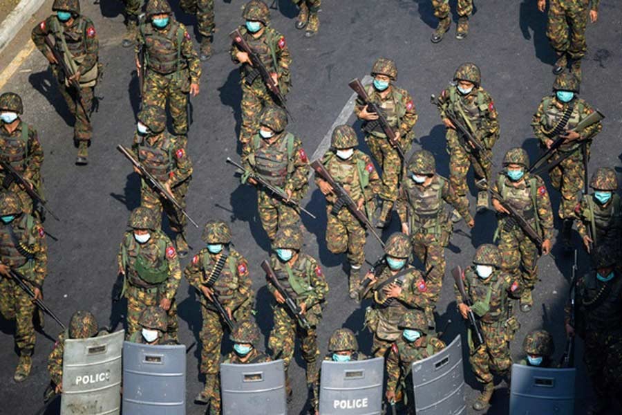 Myanmar soldiers walking along a street during a protest against the military coup in Yangon, Myanmar, in February –Reuters file photo