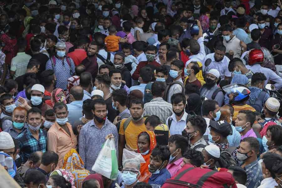 Thousands of people leaving for their native places to celebrate Eid-al-Fitr throng the Mawa ferry terminal in Munshiganj on Thursday ignoring risks of coronavirus infection –AP Photo