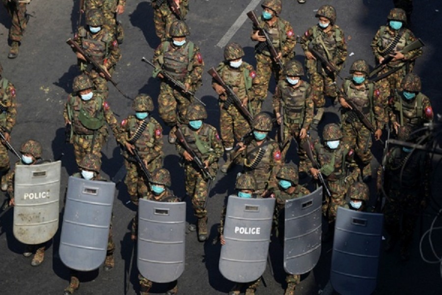 Myanmar soldiers from the 77th light infantry division walk along a street during a protest against the military coup in Yangon, Myanmar, Feb 28, 2021. REUTERS