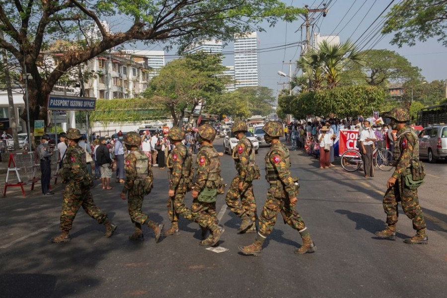 Soldiers cross a street as people gather to protest against the military coup, in Yangon, Myanmar on February 15, 2021 — Reuters/Files