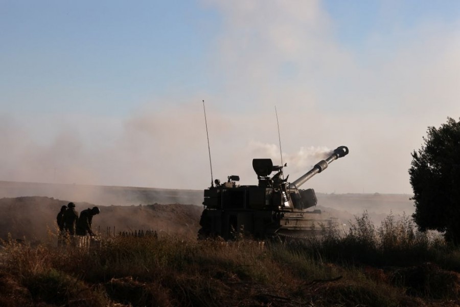 Israeli soldiers work at an artillery unit as it fires near the border between Israel and the Gaza strip, on the Israeli side on May 18, 2021 — Reuters photo