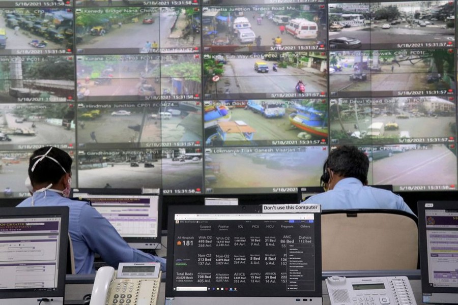 Staff members of Brihanmumbai Municipal Corporation (BMC) watch screens inside the disaster management war room to monitor the movement of people on the roads and availability of beds in Covid-19 hospitals across the city, in Mumbai, India on May 18, 2021 — Reuters/Files