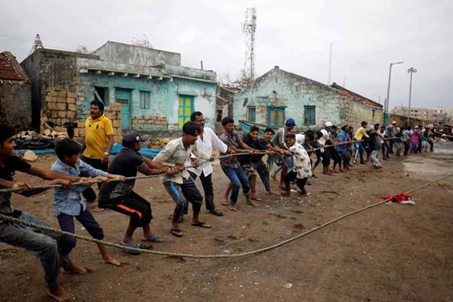 People pull a rope tied to a damaged boat after cyclone Tauktae hit, in Navabandar village, in the western state of Gujarat of India recently –Reuters file photo